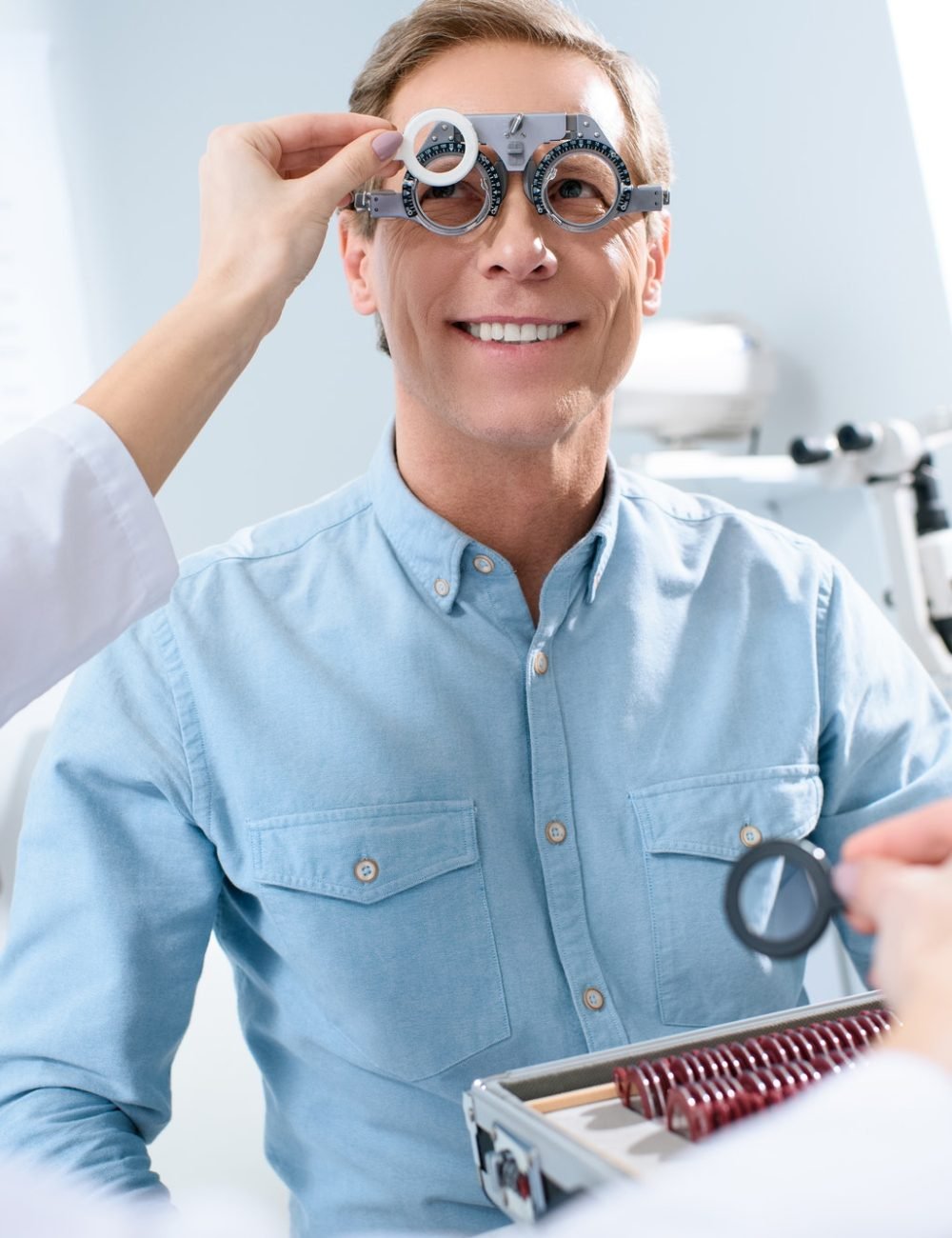 ophthalmologist-examining-middle-aged-man-eyes-with-trial-frame-and-lenses.jpg
