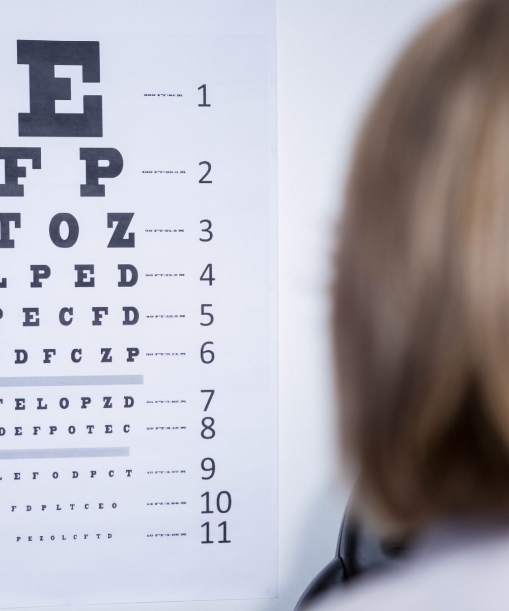 optometrist-looking-at-eye-chart.jpg